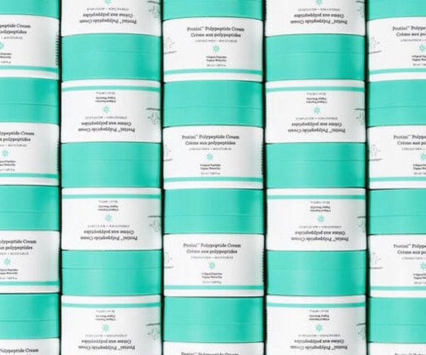 photo of Protini containers stacked on top of each other in columns ad image